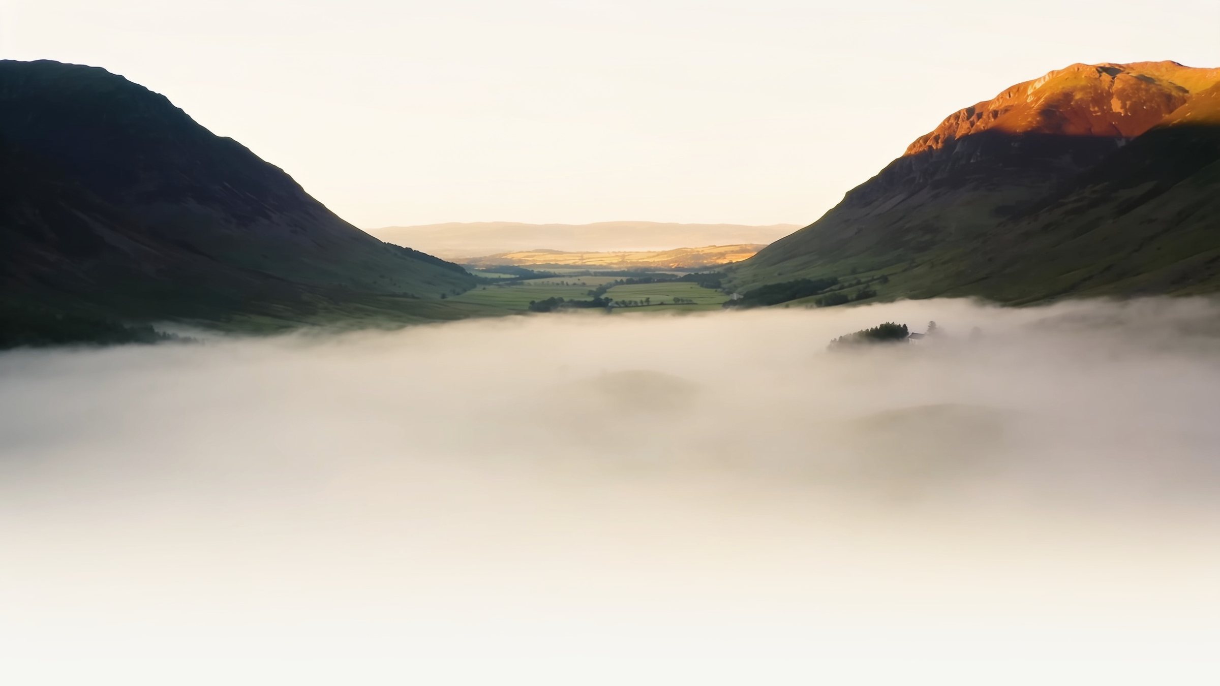 Mist settling over a quiet valley at dawn